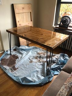 a wooden table with some hairpinks on it in the middle of a living room