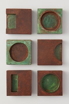 four pieces of metal with green paint on them