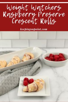 raspberry cheese rolls on a white plate next to a bowl of raspberries