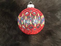 a red ornament sitting on top of a fur covered floor