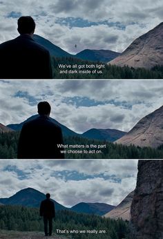 a man standing on top of a lush green field next to a tall mountain covered in clouds