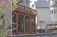 a house with a pool in front of it and an umbrella over the back door