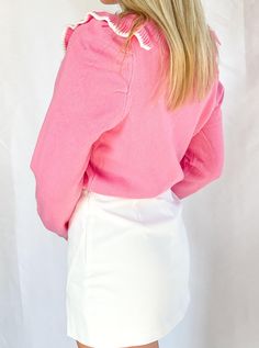 This fun and flirty sweater is perfect for any girly-girl who loves pink. With its ruffled accents and Barbie-pink hue, this sweater is sure to turn heads. Dress it up with a white skirt or dress it down with lightwash jeans. Either way, you'll be getting compliments left and right. Pink Ruffled Tops For Winter, Pink Ruffled Winter Top, Pink Spring Tops With Ribbed Cuffs, Pink Long Sleeve Sweater With Ribbed Cuffs, Chic Pink Spring Sweater, Chic Pink Sweater For Spring, Trendy Pink Sweater With Ruffles, Pink Ruffled Sweater For Winter, Pink Ruffled Winter Sweater