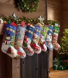 christmas stockings hanging from a mantel in front of a fireplace