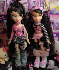 two dolls are standing next to each other