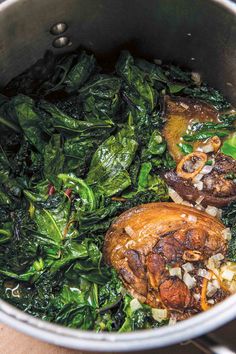 spinach and mushrooms cooking in a pot