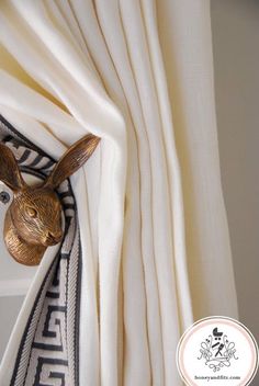 a curtain with a rabbit head hanging on it