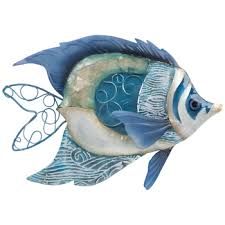 a blue and white ceramic fish with swirl designs