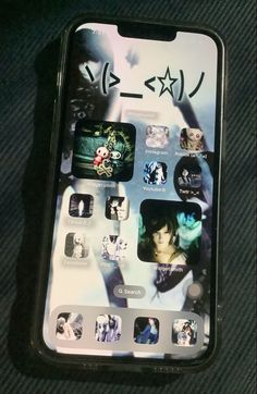 an iphone with japanese characters on the screen and other stickers attached to its back