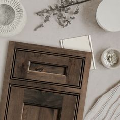 a close up of a cabinet door and some other items on a table with flowers