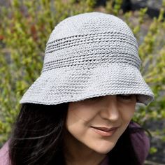 a woman wearing a gray crochet hat