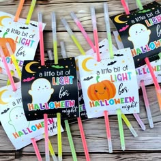 several halloween themed toothpicks are arranged on a wooden table with stickers and tags