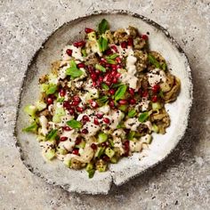 a white bowl filled with food on top of a table