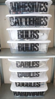 plastic storage containers stacked on top of each other in a closet with words written on them