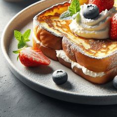 two pieces of french toast with whipped cream and strawberries