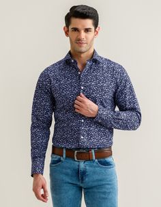 If you desire to add a graceful floral print to your wardrobe, this shirt is the right choice. We have crafted it from a soft, breathable bamboo blend that offers a luxurious feel against your skin while ensuring moisture-wicking properties. A button-up collar effortlessly helps you dress up this shirt for a formal look and dress it down for a relaxed vibe. Flowery and leafy pattern spreads all over the shirt and cobalt blue on a dark blue base adds elegance with style. Easy care bamboo blend fa Formal Floral Print Top With Spread Collar, Formal Cotton Shirt With Floral Print, Cotton Slim Fit Top With Floral Print, Slim Fit Cotton Top With Floral Print, Formal Patterned Shirt With Floral Print, Slim Fit Cotton Shirt With Floral Print, Elegant Patterned Cotton Tops, Formal Blue Floral Print Tops, Floral Pattern Shirt