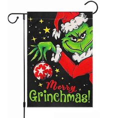 a christmas banner hanging on a pole with the words merry grinmas written in green