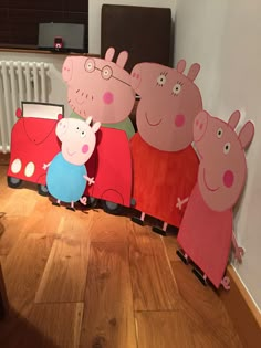 peppa pig and his friends are standing in front of some cardboard cutouts on the floor