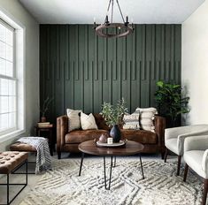 a living room with two couches and a coffee table in front of a green wall