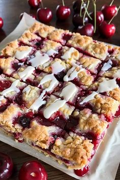 a close up of a pie on a table with cherries