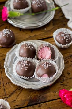 several chocolates are on a plate with pink flowers