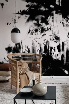 a living room with black and white paint on the wall