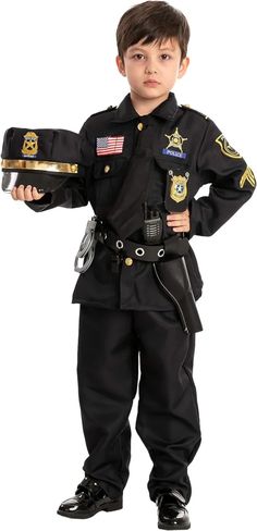 a little boy dressed up as a police officer with his hands on his hips and arms crossed