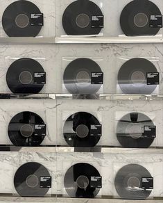 there are many different records on display in the case together, all black and white