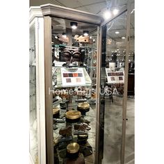 a display case filled with lots of hats and other items in glass cases at a store