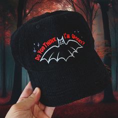 A cute and spooky corduroy hat, perfect for fall and halloween (although, you can really wear it anytime). Featuring a cute, googly eyed bat and vibrant neon red text and purple stars. This spooky hat is perfect for fall, night around the campfire, and cozy nights. But, it’s light and breathable enough that it’s great for year round use too! Get this hat today and look super stylish for spooky season and beyond. Embroidered directly onto a super soft corduroy hat, that's sure to become your new Cryptidcore Hat, Purple Stars, Cute And Spooky, Fall Night, Corduroy Hat, Around The Campfire, Fall And Halloween, Neon Red, Googly Eyes