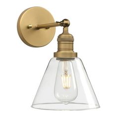 an antique brass finish wall light with clear glass shade