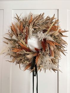 a dried wreath hanging on the front door