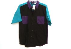 Great 80s color block purple, teal, and dark green button down short sleeve shirt. New with original tags. Three available. Boys sizing, but fits similar to womens small/mediums. Purple/green boys L 14-16, Black/purple boys XL 18-20, Black/purple boys M 10-12 Please check measurements to ensure best fit: Size M Measures approx 18.5 inches pit to pit and 23 inches in length Size L Measures approx 20.5 inches pit to pit and 26 inches in length Size XL measures approx 21.5 inches pit to pit and 28 Fitted Cotton Color Block Shirt, Fitted Cotton Shirt With Color Block, Green Short Sleeve Color Block Shirt, Green Color Block Short Sleeve Shirt, Retro Short Sleeve Purple Shirt, Purple Short Sleeve Shirt With Buttons, Retro Purple Short Sleeve Shirt, Retro Purple Cotton Shirt, Purple Cotton Retro Shirt