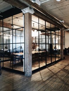 an open room with glass walls and wooden floors is seen on the instagram page