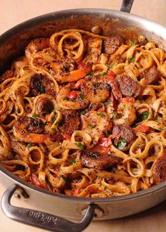 pasta with shrimp, peppers and onions in a skillet ready to be eaten for lunch