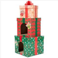 three boxes stacked on top of each other with christmas wrapping around the edges and bows