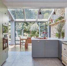 a kitchen with an oven, sink and table in the center is seen from outside