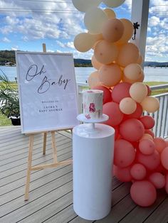 balloons are stacked on top of each other in front of a sign