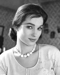 black and white photograph of a woman wearing a pearl necklace