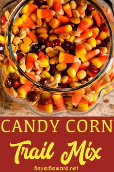 candy corn trail mix in a glass bowl with text overlay that reads candy corn trail mix