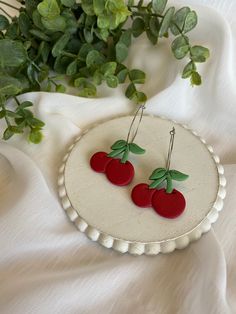 This pair of earrings is made with green and red polymer clay and silver colored hoops.  These would be perfect for anyone who loves cherries.  If you love these earrings snatch them up before someone else does.  If you have any questions or concerns feel free to contact owner and designer at HannahsJeweltique@gmail.com Visit my website at HannahsJeweltique.com Trendy Red Nickel-free Hoop Earrings, Playful Nickel-free Red Earrings, Playful Red Dangle Jewelry, Playful Red Nickel-free Jewelry, Fun Red Round Jewelry, Cherry Earrings, Green And Red, If You Love, Kitchen Accessories