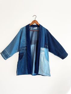 This kimono in non-stretch denim patchwork coat is a one-of-a-kind statement piece crafted from repurposed denim jeans. -Functional patch pockets. -Unique patchwork design showcases the beauty of the denim details, creating a distinct look. -Each jacket is cut and sewn in our Toronto studio, ensuring quality and sustainability using repurposed jeans. -100% lightweight cotton. Comfort and style while making a positive impact on the planet! Repurposed Jeans, Jeans Denim Jacket, Patchwork Kimono, Repurposed Denim, Patchwork Coat, Recycled Jeans, Jacket With Pockets, Denim Patchwork, Denim Details