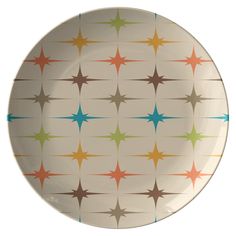 a white plate with multicolored stars on the front and sides, against a white background