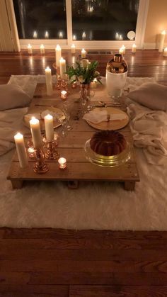 a tray with candles on top of a bed