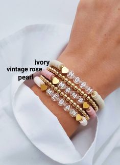 three bracelets with gold hearts on them