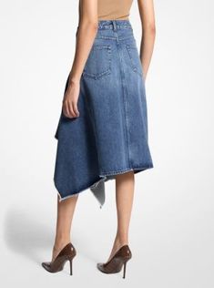 Imbued with an architectural edge, this denim skirt features asymmetrical, cascading ruffles that descend to a flattering knee-grazing length. Italian-made, this skirt is crafted from organic cotton for an effortless drape and soft handle. Wear it with a leather belt to further define the high-rise waist. Asymmetrical Cotton Denim Skirt, Asymmetrical Cotton Denim Skirt For Spring, Chic Asymmetrical Fitted Denim Skirt, Chic Fitted Asymmetrical Denim Skirt, Fitted Chic Asymmetrical Denim Skirt, Asymmetrical Cotton Skirt For Spring, Spring Asymmetrical Cotton Skirt, Chic Asymmetrical Cotton Bottoms, Asymmetrical Fitted Denim Skirt For Spring