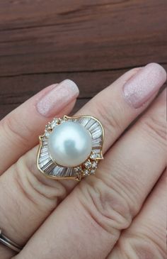 "ATTENTION BUYERS.. PLEASE READ ANNOUNCEMENT IN MY SHOP. it's very important information there about purchasing items. Must purchase thru Etsy only, NOT from \" Offsite ads\"Stunning Vintage 14k Yellow Gold, South Sea, Salt Water 12.34mm White Pearl, approximately 2ct  Baguette And Round Diamonds Wedding Engagement Cocktail Ballerina Ring.. Ring Measurements is approximately 22.58mm x 20mm Diamonds is SII, GH. Weight is 9.3 Grams Size 5 1/4, sizable. Some pics enlarged to see details All sales are final, no return. Ring look Spectacular, Rich and Classy on your finger. US shipping overnight with insurance only $59 International shipping with USPS Express $89 All Dimensions, Measurements and description is approximately Layaway plan is available Ring will come in nice gift box..ATTENTION BU White High Luster Pearl Ring For Wedding, Exquisite High Luster Rings For Wedding, Aaa Quality Baguette Cut Wedding Jewelry, High Luster Diamond Wedding Rings, Navette Ring, Ballerina Ring, Gold Pearl Ring, Gold Ring Designs, Diamond Jewelry Designs