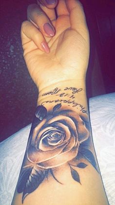 a woman's arm with a rose tattoo on it and the words written in french