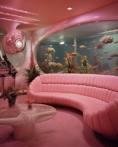 a living room filled with pink furniture and fish tank