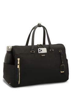 Leather trim subtly elevates this modern duffle bag with plenty of space to keep you organized no matter where you're going. A removable, adjustable crossbody strap means convertible convenience each time you choose this bag with quick-access pockets on the outside and a water-resistant water-bottle pocket. This bag includes Tumi Tracer®, an exclusive, complimentary program that helps reunite lost or stolen bags with their rightful owners using a one-of-a-kind 20-digit number affixed to the bag Versatile On-the-go Luggage With Detachable Strap, Versatile Travel Duffle Bag With Detachable Strap, Functional Luggage With Detachable Strap For Everyday Use, Functional Everyday Luggage With Detachable Strap, Elegant Travel Bag With Adjustable Strap For Everyday Use, Elegant Crossbody Travel Bag With Adjustable Strap, Elegant Weekender Bag With Adjustable Strap And Top Handle, Elegant Weekender Bag With Top Handle And Adjustable Strap, Functional Weekender Bag With Detachable Strap For On-the-go